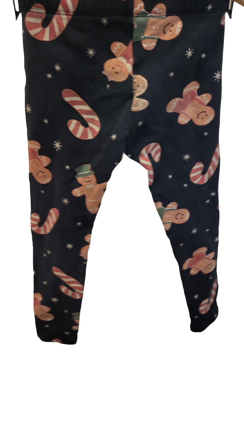 Back of the navy leggings, showing the same gingerbread and candy cane print on the seat and legs.