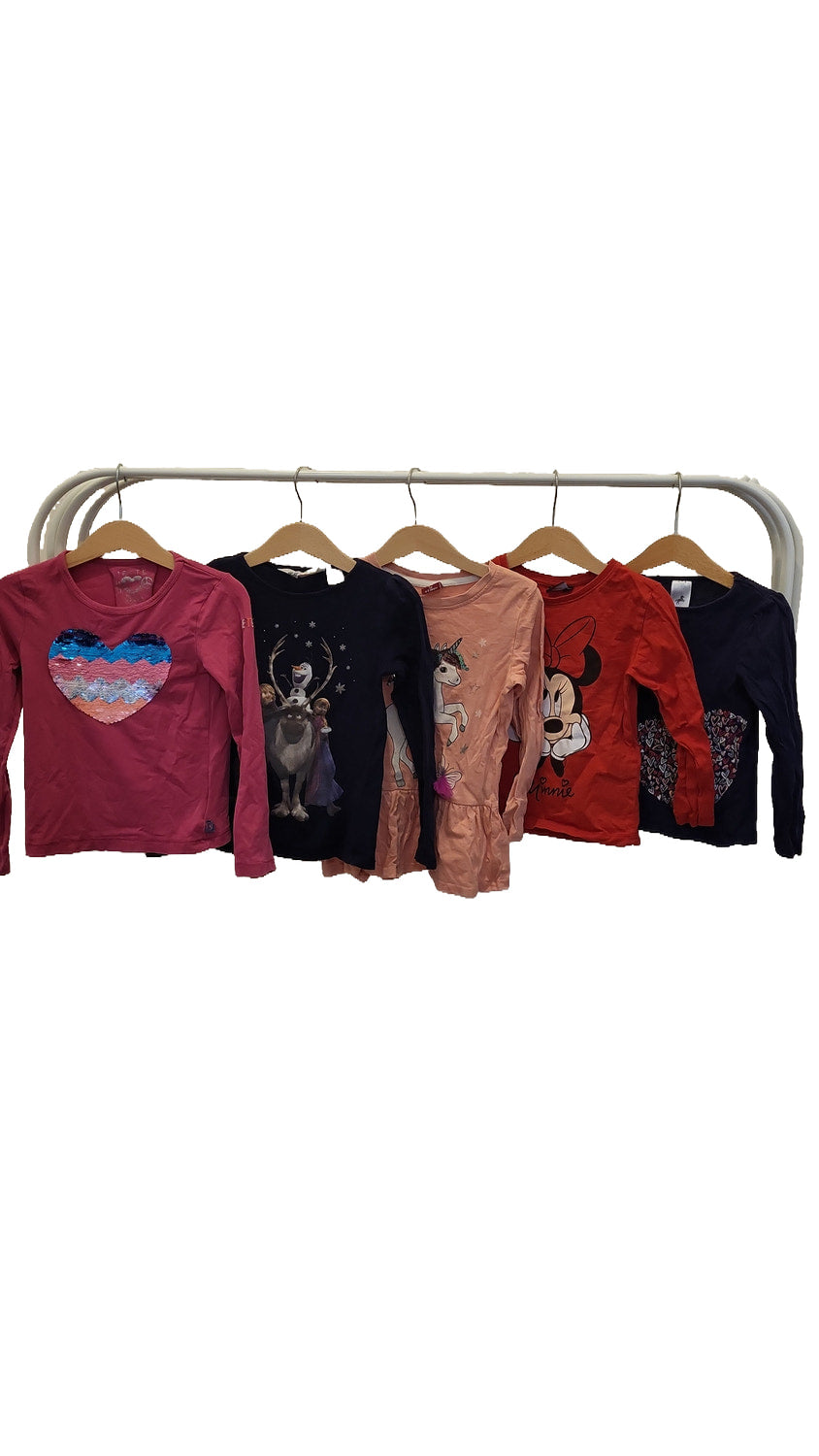 Five long-sleeved girls' tops hanging on a rail, from left to right: pink with a sequin heart, navy with Frozen characters, peach with a unicorn, red with Minnie Mouse, and navy with hearts.